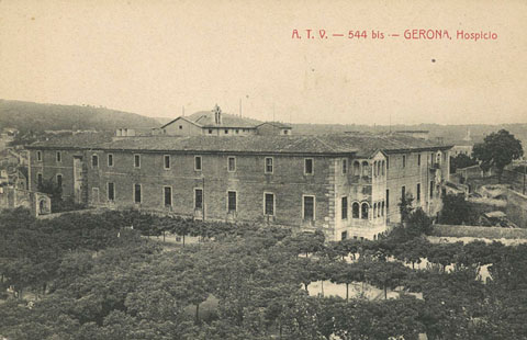 Vista de l'Hospici des de l'avinguda de Sant Francesc. En primer terme, el pati que posteriorment es convertiria en la plaça de la Diputació. A la dreta, un tram de la muralla de Jaume I. 1905-1911