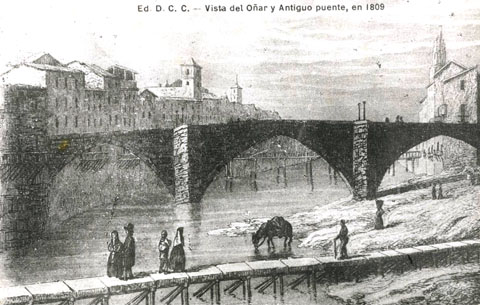 Gravat d'una vista del riu Onyar a Girona, amb el pont de Sant Francesc a la part central i amb la passera del portal de l'Àngel en primer terme. A l'esquerra del riu, el campanar de l'església de les Bernardes i el de Santa Clara. A la dreta, el campanar de l'església de Sant Feliu. 1842