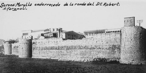 Vista parcial del tram de muralla del Mercadal compresa entre els baluards de Sant Francesc i el de Santa Clara, paral·lel a la ronda del Doctor Robert, posterior ronda Pare Claret. En segon pla, l'edifici de l'hospital de Santa Caterina. 1910-1915