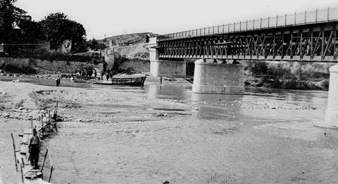 El Pont de la Barca en fase de construcció. Sota el pont, la barca de llibant que dóna nom al pont. 1902